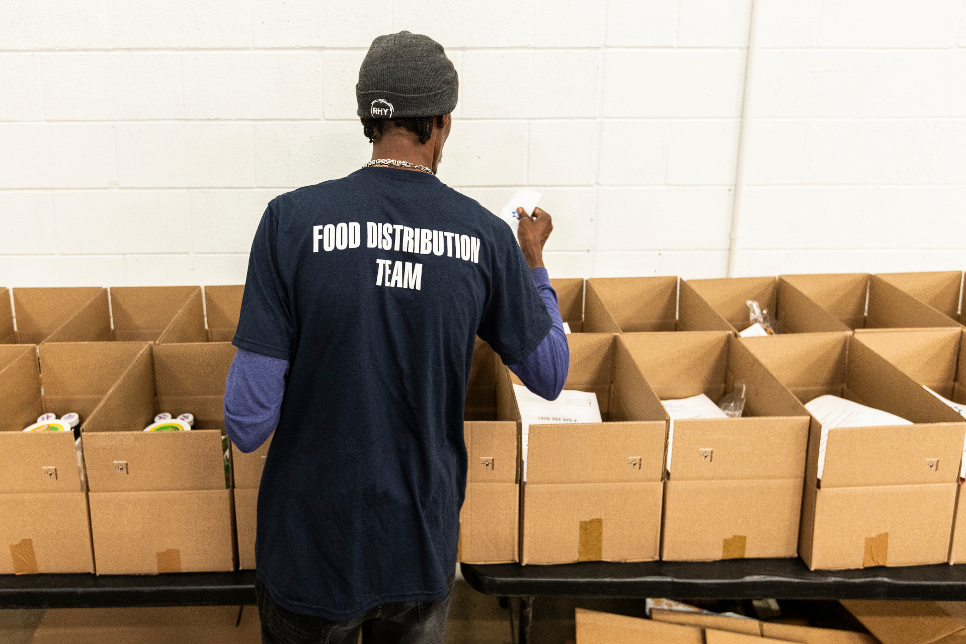 Met Council Food Distribution Team member preparing boxes for delivery