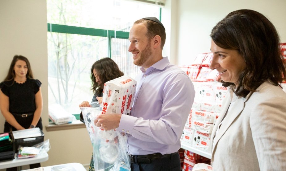 David Greenfield handing out baby supplies with Met Council staff
